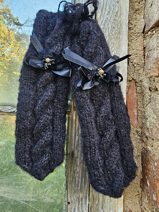 Knitted mittens with braids and bow - black