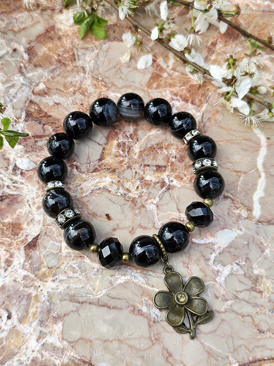 Natural stone bead bracelet - black with bronze color elements and flower pendant