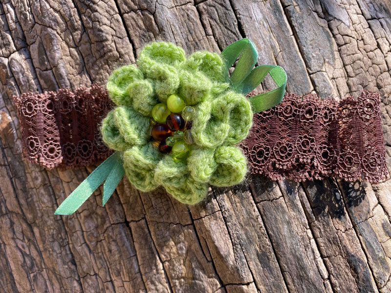 Lace headband with crocheted flower - green with brown 