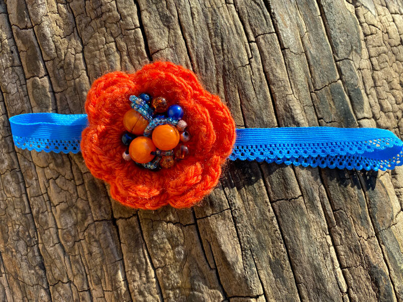 Lace headband with crocheted flower - orange with blue 